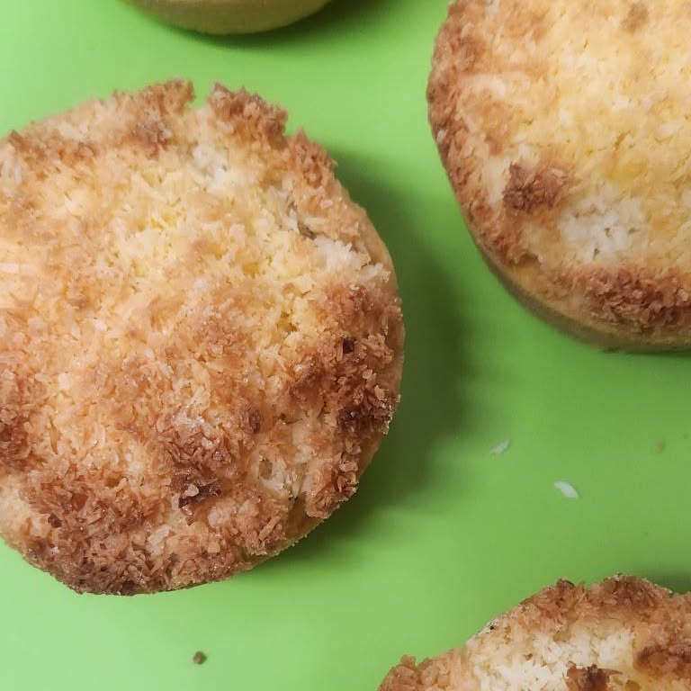 Golden coconut cakes on a green board