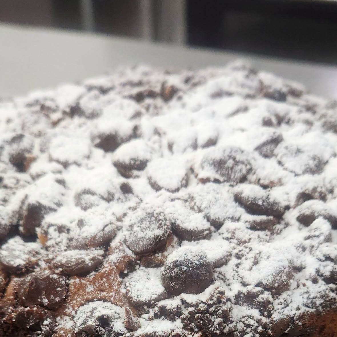 Chocolate chip crumble cake dusted with icing sugar