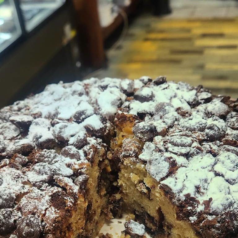 A cut chocolate chip cake showing the crumb