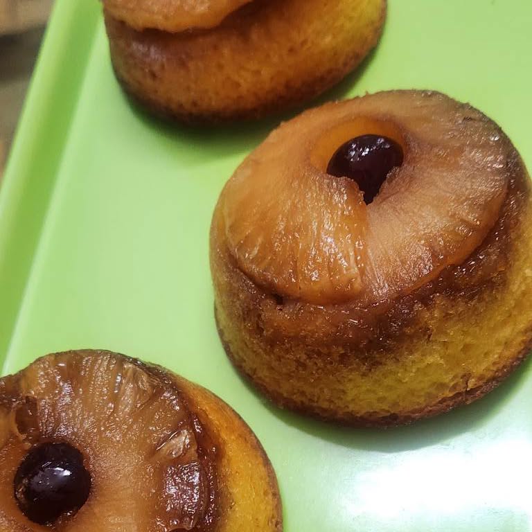 Little pineapple upside-down cakes, each with a cherry