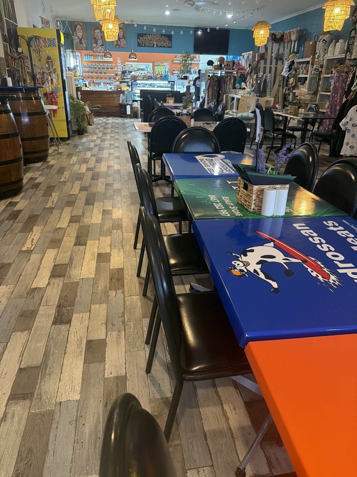 The long room: painted tables down one side, gift shelves down the other